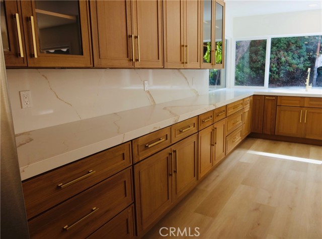 Beautiful Cabinetry with Beveled Glass, Timeless quartz countertops and Elegant Hardware.
