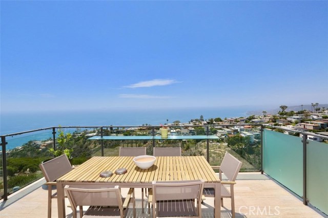 917 Quivera Street Laguna Beach, California Enjoy spectacular views from this furnished 3 bedroom, 3 bath home! The house is located on one of the lower streets in Arch Beach Heights which provides panoramic views from every level. The kitchen and dining room are on the upper level along with the living room which has exposed beam and cathedral ceilings as well as a fireplace and access to one of the decks. There are two bedrooms and two baths on the middle level as well as the laundry area. Enjoy the amazing view from the master suite and private deck on the lower level complete with a newly renovated gorgeous bathroom with dual sinks, a large shower and spacious closet. There is a bar area in the master with a small sink and custom cabinetry. Beautiful bamboo floors throughout each level of this awesome home. Available June ($7000) and July (8500)