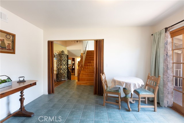 A view from the kitchen to the lower level and stairs to the upper level