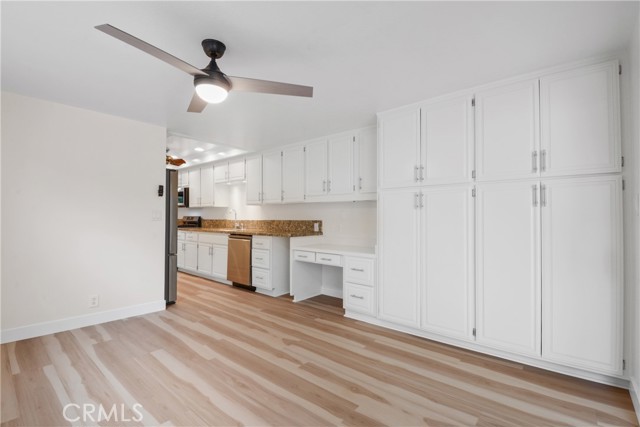 Another view from family kitchen featuring plenty of storage and a convenient kitchen desk.