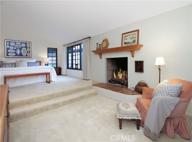 Large and spacious primary bedroom with sitting area and fireplace