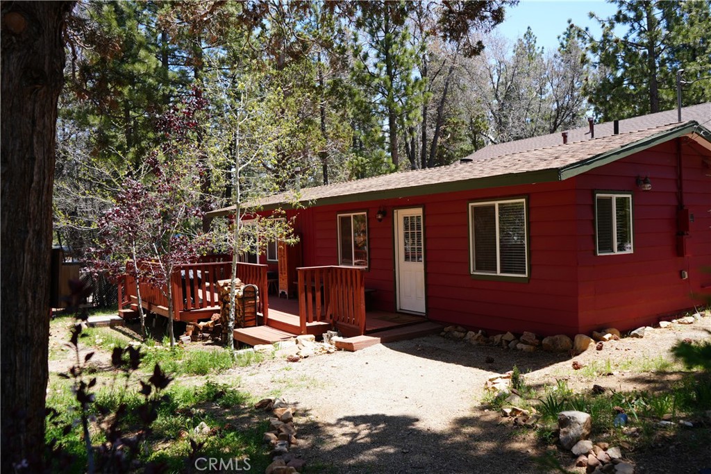 This two bedroom one bath open concept will pull you into the mountain life! At almost 800 sq ft this cabin can sleep 7. The spacious flat private treed lot has plenty of room for more sheds, a garden, or you and your loved ones to have a blast. Step inside to discover oak flooring, vaulted T & G ceilings, and a cozy wood-burning stove on a raised hearth. The kitchen boasts stainless steel appliances, perfect for whipping up culinary delights. Most of the furniture and beds are included. Stay warm on snowy nights with the Rinnai energy-efficient wood stove and enjoy the convenience of a washer & dryer in the home. Nestled in a treed forest with a fully fenced yard and a delightful deck, this home is your gateway to enjoying the stunning Big Bear weather and sparkly star filled nights. It’s just two blocks away from the National Forest, offering access to hiking and biking trails and also a quick walk to Easy's General Store and Kallans Restaurant.