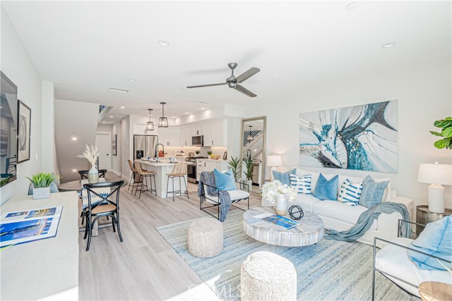 View of living room and kitchen area from balcony.