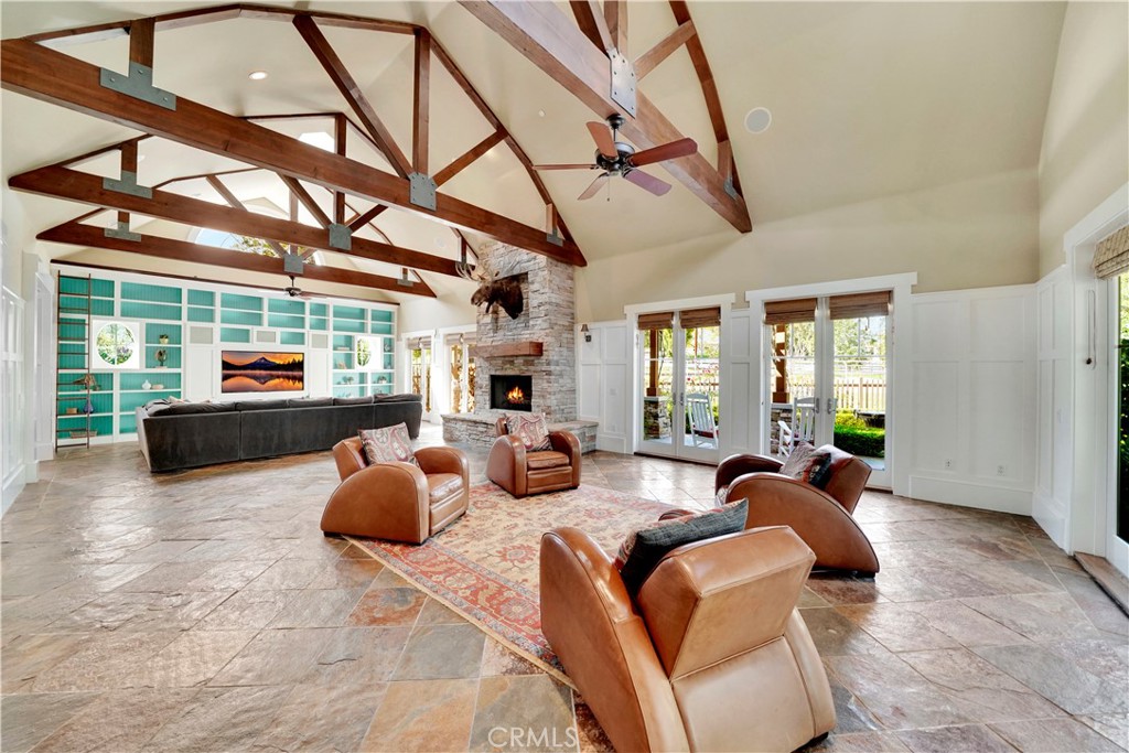 great room with spectacular open beam ceiling and stone floors