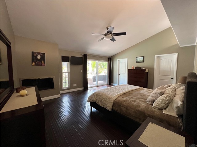 Master bedroom with high ceiling, walk-in closet, gas fireplace and pool view