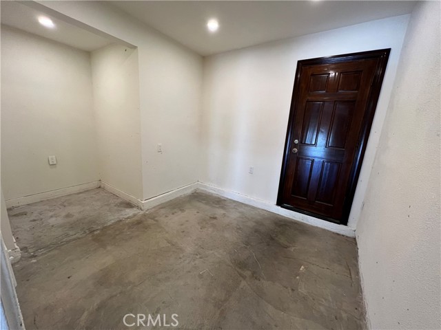 Storage room or office in the garage. The door leads to the side/back yard next to the kitchen side door.