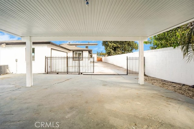 View from covered carport towards front view of property