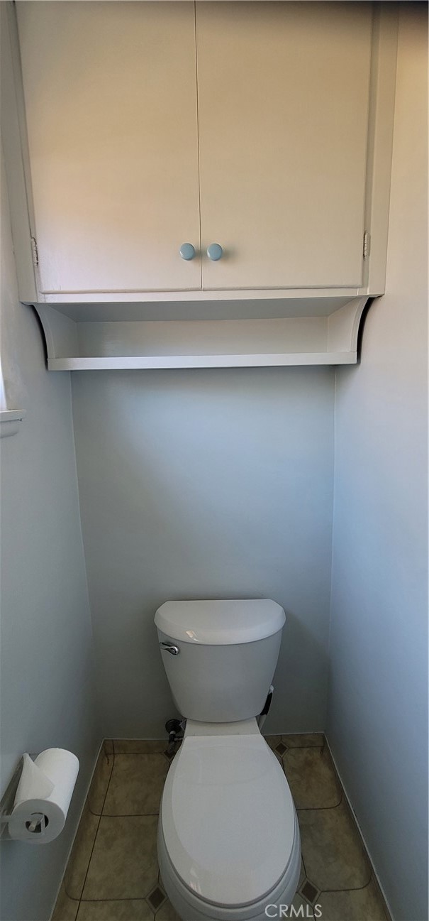 2nd bathroom, new toilet and overhead storage cabinet.