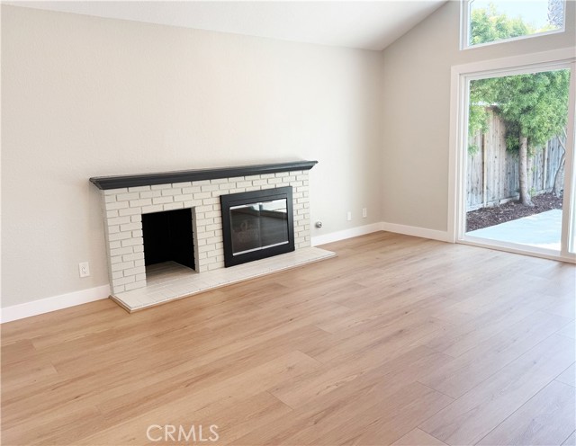 Living room with fire place and newly installed flooring