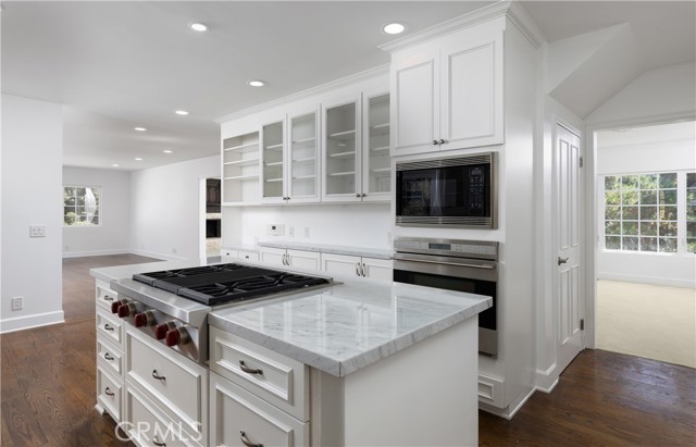 9473 Rembert Lane Beverly Hills, California Location Location Location has never rang truer. Nestled in the hills off Coldwater and Cherokee. Wind yourself up the two lane road to your beautiful home. Live amongst the producers, singers, directors, politicians and Kings. This beautiful 4 bed 4 bath is finally on the market. Upgraded features throughout. Oak floors downstairs and at upstairs landing. Wolf range and double ovens, sub zero refrigerator are a few of the appliances in the kitchen. The Carrara marble tops and backsplash blend nicely with the white solid wood cabinetry. Butler pantry and dry bar are strategically placed between kitchen and dining room. The over sized great room adjacent to the kitchen offers a fun family room or an entertainers delight. One bedroom downstairs is perfect for the maids quarters. The beautiful 225 year old marble fireplace in front room is breathtaking. It is surrounded by a very ornate custom oak bookcase. Master room and over sized bathroom are a dream. The large secondary rooms share a large Jack and Jill bathroom. The Grand room upstairs leads to an open balcony with views of the neighboring green trees and hills. This home is an amazing canvas to truly make your own. This will not be on the market long.