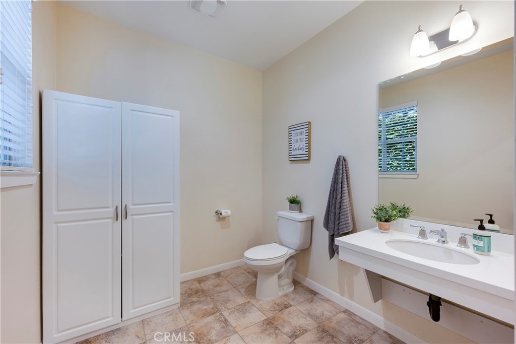 Downstairs Bathroom has Large Built-in Storage and Tile Flooring!