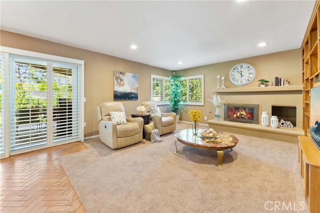 Spacious family room with recessed lighting, fireplace, double pane windows and slider to covered patio area.