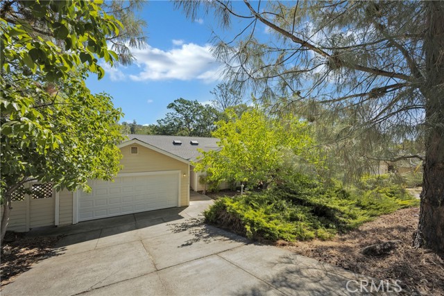 18278 North Shore Drive Hidden Valley Lake, California Ideally located around the corner from Lake access, this charming 3 bed / 2 bath home has 1,482 SF situated on nearly a quarter acre. Enter to find soaring vaulted ceilings, newer laminate wood flooring and ceiling fans throughout. Kitchen with tile countertops, offers plenty of space for cooking or entertaining and loads or storage space with cabinetry galore. Dining can be enjoyed at the the nook in the kitchen or the formal dining room adjacent to the kitchen. Sliding glass doors lead you to a large deck where you will find views of undeveloped land with a park-like setting. Watch deer meander or listen to the birds sing, it's so peaceful! 2 spacious bedrooms and a hall bath with a tiled countertop and tub/shower combo. Master has vaulted ceiling, private deck, ensuite bath with dual sink vanity, walk-in tile shower and an accommodating walk-in closet that is sure to please. Indoor laundry is a bonus! New HVAC! 2 car garage offers plenty of storage. With Lake amenities such as Little Beach, North Shore Park & the Marina nearby, what more could you ask for?