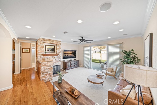 Large living room with gas fireplace, newly installed carpet and fresh paint. liner leading to backyard