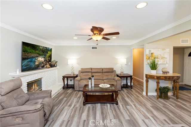 Family Room with Fireplace - Crown molding adds a wonderful design touch to the space.