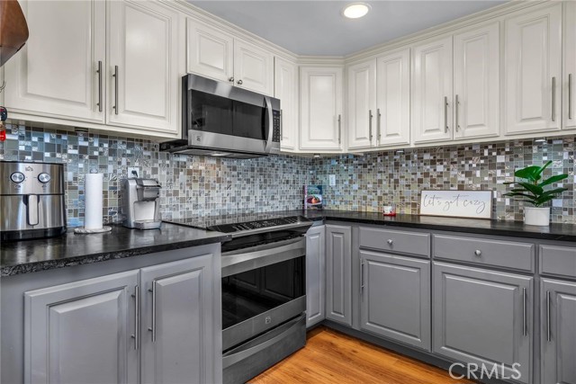 stone counter and mosaic backsplash