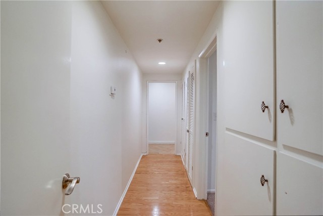 Long hallway leading to Bedrooms with additional cupboards for linens and storage. Long hallway leading to Bedrooms with additional cupboards for linens and storage.