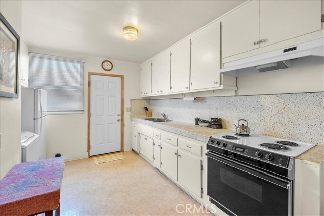 Kitchen with access to side of house via side door.