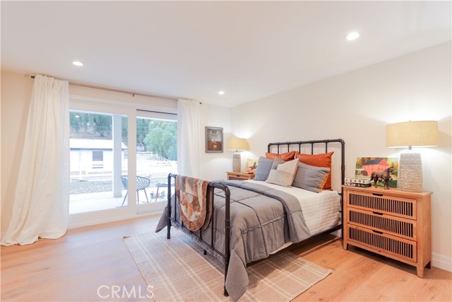 Staged as a boy\'s room, this secondary ensuite bedroom is well-appointed with direct patio access, abundant natural light and a relaxed indoor-outdoor feel.