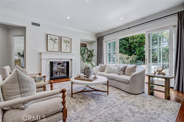 Formal Living Room Area with Marble Fireplace and French Door Access to Backyard Patio