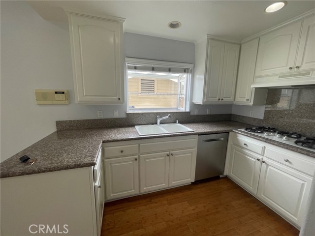 Kitchen with garden window, granite counter tops and beautiful white cabinets