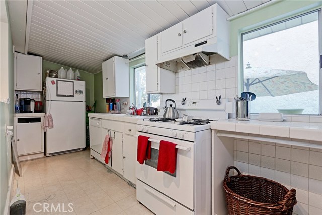 Unit A Kitchen w windows overlooking the backyard between the units.