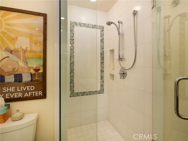 Beautifully tiled remodeled shower in hall bath.