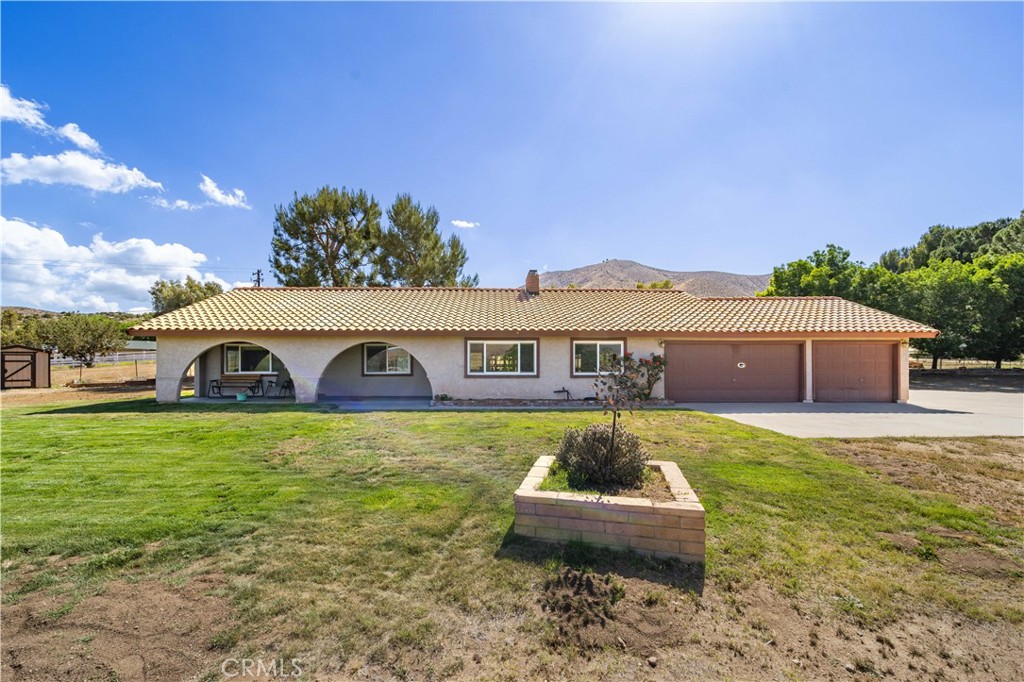 4020 9th Street Acton, California First time on the market! Welcome to peaceful Country Living featuring 3 Bedrooms, 2 Bathrooms on 2.33 Acres. Great layout with a blend of designated and open space: entertain in the living room, host gatherings in the dining room or cozy-up in front of the fireplace, in both the living and dining rooms. The kitchen will delight the chef, with updated, soft-close cabinetry and drawers, quartz countertops, stainless appliances, abundant storage with pull out drawers and an adjacent breakfast nook. The home has 3 spacious bedrooms, but the Primary Bedroom is a retreat, with its own bathroom with walk-in shower, plus a large closet. An indoor laundry room is a welcome convenience providing extra storage and has direct access to the attached 3-Car garage. The home has been meticulously maintained with a newer A/C and dual paned windows. The yard has the perfect blend of manicured entertaining space combined with flat, usable land, large enough for a garage, barn and horses. Functional outbuildings on the property include 2 sheds. The property is fully fenced with a security gate in the driveway. Close to all amenities, county water, natural gas and easy freeway access.