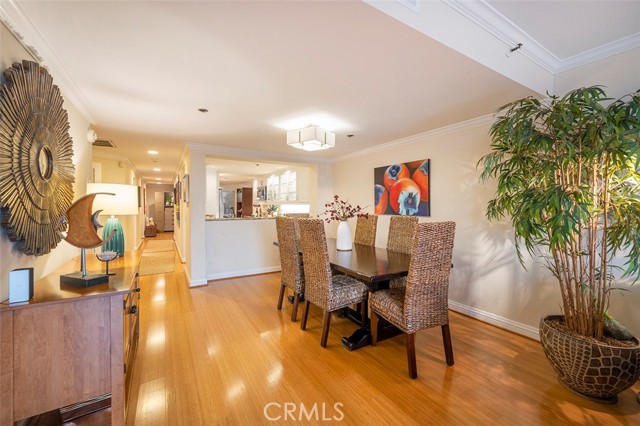 Dining room with view to the kitchen and entrance to the unit at the end of hallway. Bedrooms are on the left side