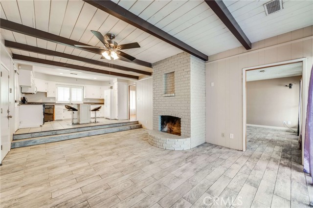 Step down Family Room with beamed ceilings and fireplace