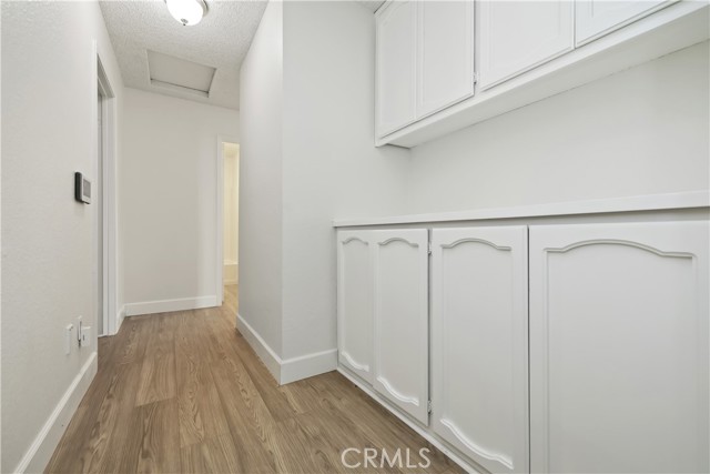 Hallway to bedrooms with upper and lower storage