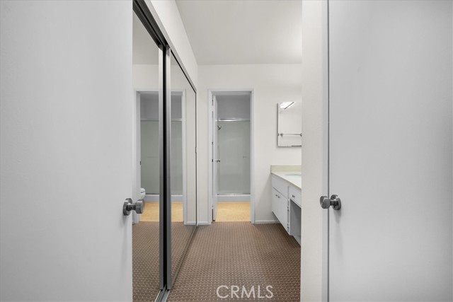 Primary bedroom closet and vanity.