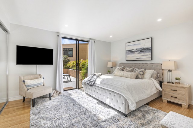 Master bedroom has mirrored closet doors, separate walk-in closet, and access to the patio