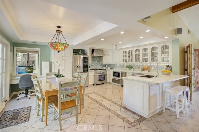 In kitchen dining and convenient work space/office in the background.