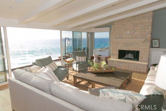 22 Lagunita Drive Laguna Beach, California Experience the finest beach-front living in all of Southern California in the most exclusive and private gated community in Laguna Beach, Lagunita—a quaint haven for celebrities and executives. This spectacular 3 bedroom, 4 1/2 bath is an entertainer’s dream and has been designed to maximize the ocean views with walls of glass that open off of the spacious and open living area. Breathtaking Victoria Beach ocean-front luxury property with steps to the sand. Just a short distance from Montage Resort.
Ocean views with walls of glass that open off of the spacious and open living area. The great room suite, which encompasses the living room and dining room. Chef’s kitchen boasts large center island, chef-grade appliances, and sun-drenched breakfast room. All three bedrooms are situated on the lower level. The master suite features ocean-front views and a luxurious master bathroom with oversized tub, steam shower, and sauna. Two large ocean-front decks are perfect for enjoying the sunset. Panoramic ocean and island views, private beach access, and lush landscaped grounds.
