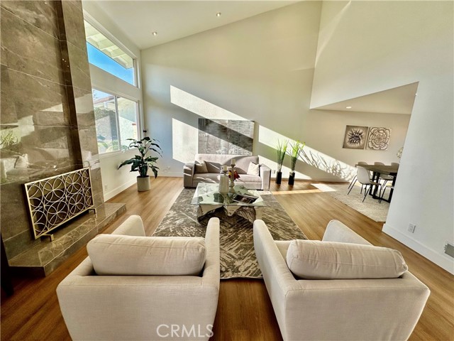 Modern Luxury Meets High Tech in this completely upgraded and redecorated Villa Park Home.  Totally turn key, this property checks all the boxes.  You will be greeted with a huge open floor plan with high open ceilings, gorgeous marble clad fireplace, large dining room, and it is all flooded with glorious natural light.  The cook's kitchen is equally stunning with quartz countertops including the large and long island, all newer soft close cabinets, newer appliances including refrigerator and wine frig, a full pantry, under counter lighting, and pass through window to the lovely backyard with pool and spa.  Luxury vinyl waterproof plank floors make entertaining a no stress affair, even with wet pool feet.  The second fireplace is located in the family room, but if you look up, you will barely notice a tucked away 133" Home Theater Screen which remotely lowers to create your very own Home Theater.  Very professional equipment even for the most avid Audio Visual enthusiast.  Evanesce Tab-Ten CineGrey 5D screen, Ben Q ceiling mounted projector and Audio by Onkyo Receiver and Klipsch premium directional Ceiling Speaker and Sub-woofer.  The sun room provides lovely space to soak up the sun, even on a chilly day.  There is 1 bedroom downstairs with the additional 3 bedrooms upstairs.  Could easily be made in to a 5 bedroom house.  The main suite is fit for a king or queen with an enormous luxury spa like bathroom, tall beamed ceilings, and a closet that is literally the size of a typical bedroom.  If you have been looking to just unpack and immediately start enjoying this beautiful like new pool property, this gorgeous home will not disappoint.