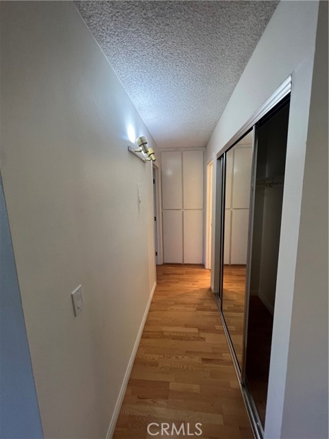 hallway with a large sliding glass mirrored closet