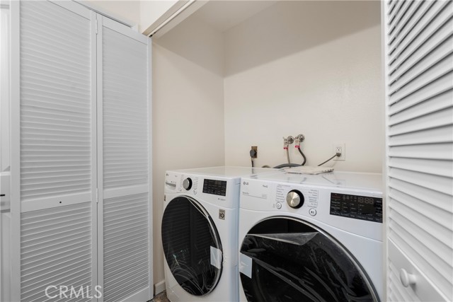 Laundry inside Hallway Bath Room with New Dryer and
