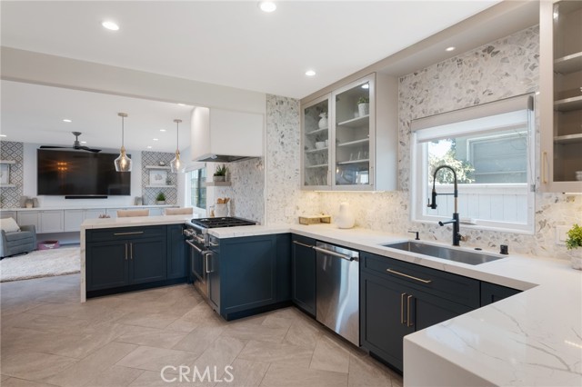 Absolutely impeccable kitchen with Calacatta premium quartz counters, marble mosaic backslash, Thermadoor appliances with Bluetooth tech, Zephyr vent, stainless steel sink, stainless steel trim, LED lights under counter cabinets and so much more!