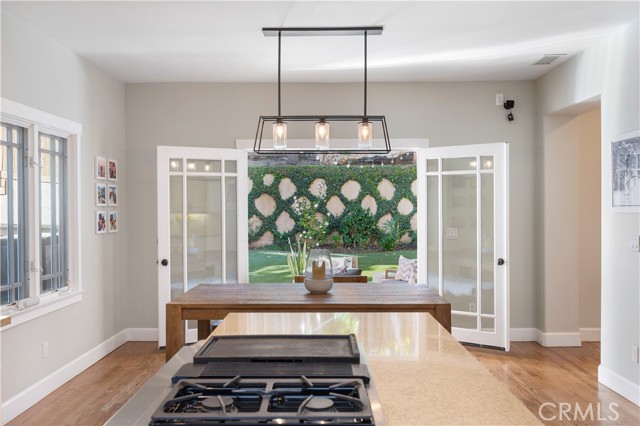 Kitchen and Breakfast Table with French Doors Opening to the Lush Backyard