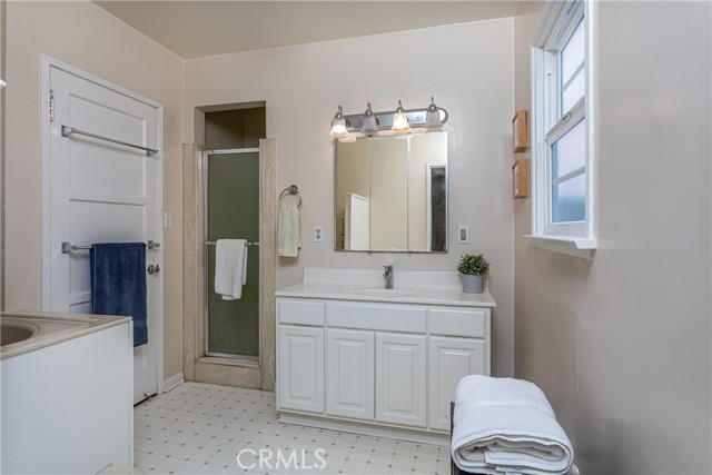 The main bathroom with separate shower and large, jetted soaking tub.