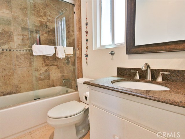 The secondary bedroom bath with upgraded shower and sink.