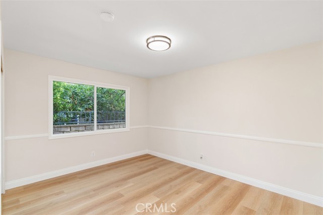 Bedroom number 3 featuring new large double pane window and new flooring