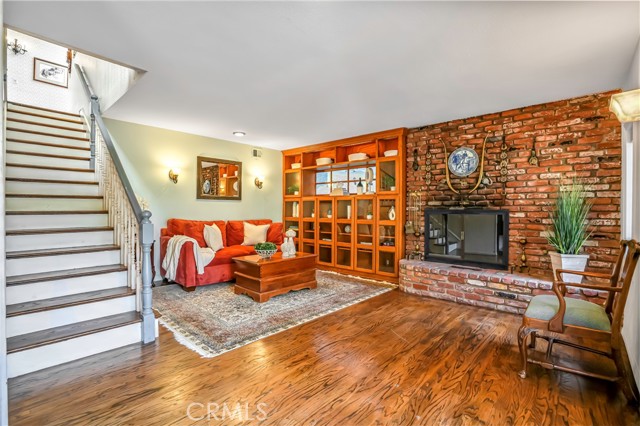 Living room is downstairs and features a fireplace and hand painted fresco above the bookshelf (don't miss!)