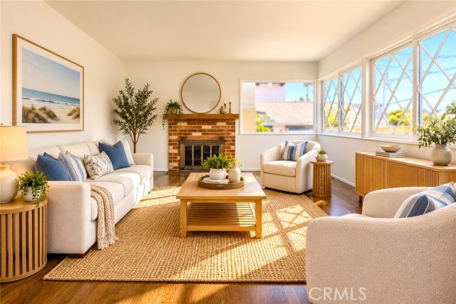 The Living Room Has a Fireplace and Refinished Hardwood Floors, which Run Throughout the Home. Virtually Staged