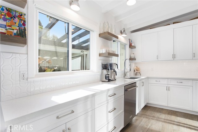 Light, bright kitchen with stainless steel appliances.
