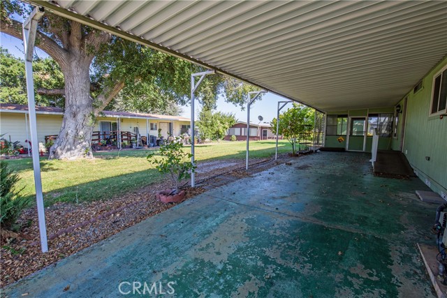 Covered carport with screened-in work area at back