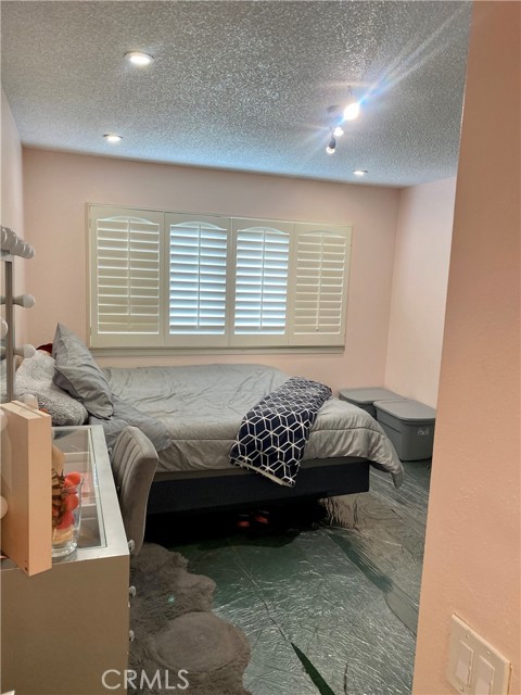 Bedroom #1 Primary bedroom with recessed lights and plantation shutters.