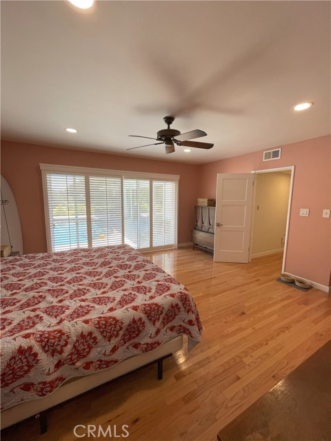 Primary bedroom with window view out to pool