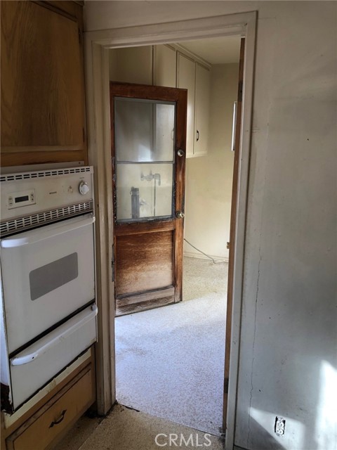 Laundry room off kitchen with door to back patio